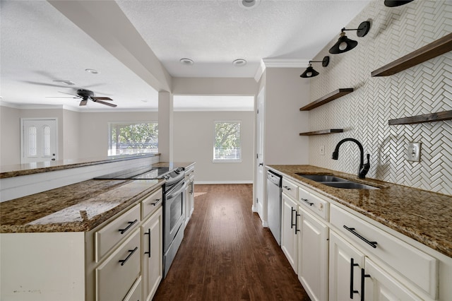 kitchen with sink, dark stone countertops, ornamental molding, dark hardwood / wood-style flooring, and white cabinetry