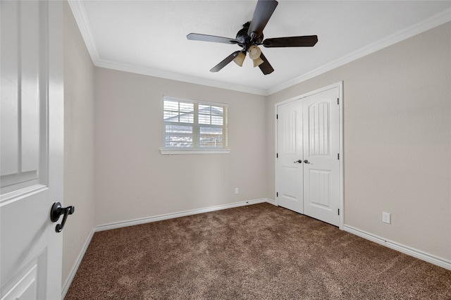 unfurnished bedroom with ceiling fan, crown molding, and dark colored carpet