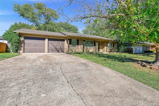 ranch-style house featuring a garage and a front lawn