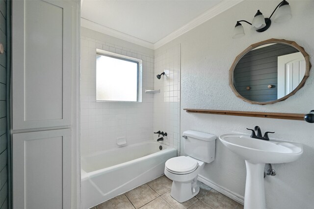 bathroom featuring tile patterned floors, toilet, tiled shower / bath, and ornamental molding