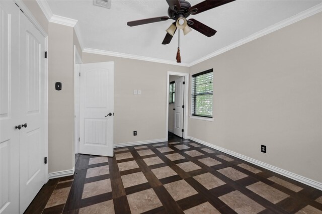 unfurnished bedroom featuring ceiling fan, crown molding, and a closet