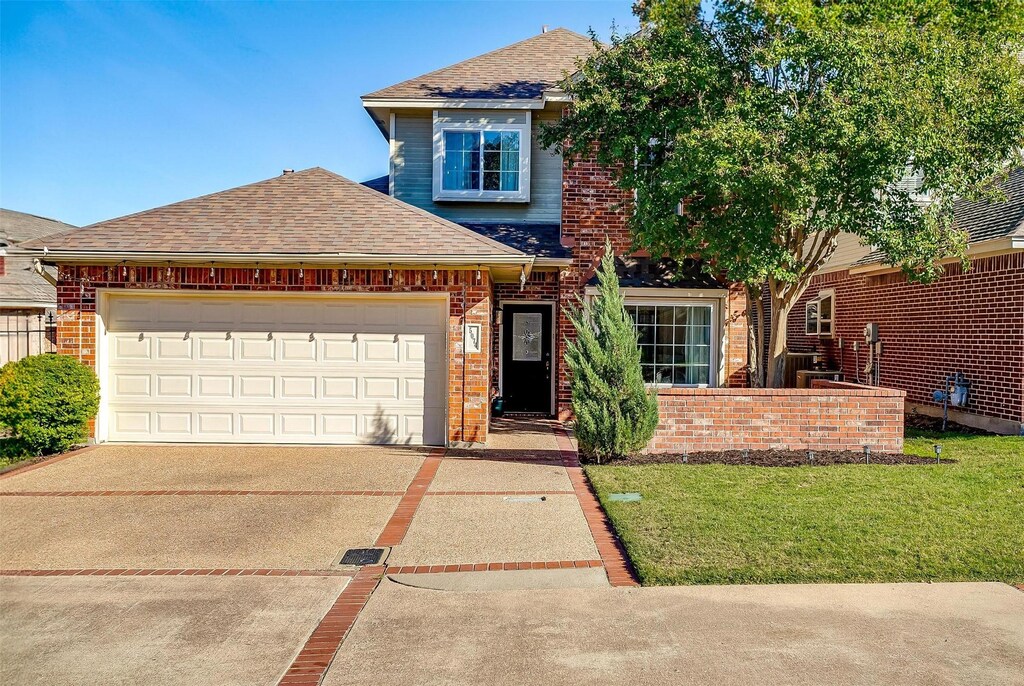 front of property featuring a garage and a front lawn