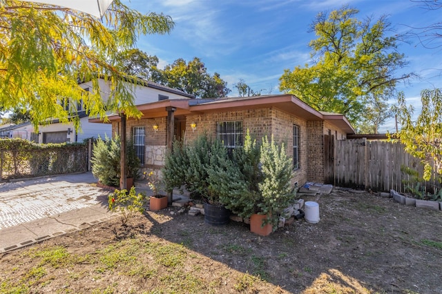 view of front of property with fence and brick siding