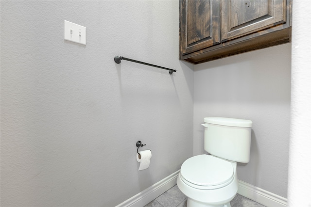 bathroom with tile patterned flooring and toilet