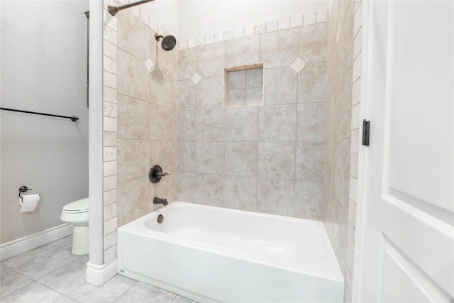 bathroom featuring tile patterned floors, toilet, and tiled shower / bath