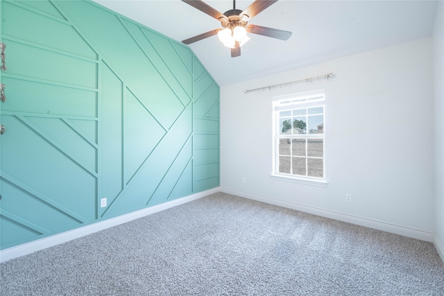 carpeted empty room featuring ceiling fan and vaulted ceiling