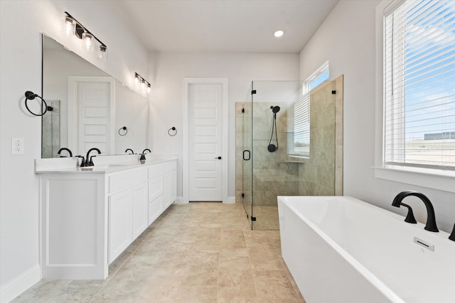 bathroom featuring tile patterned flooring, vanity, and shower with separate bathtub