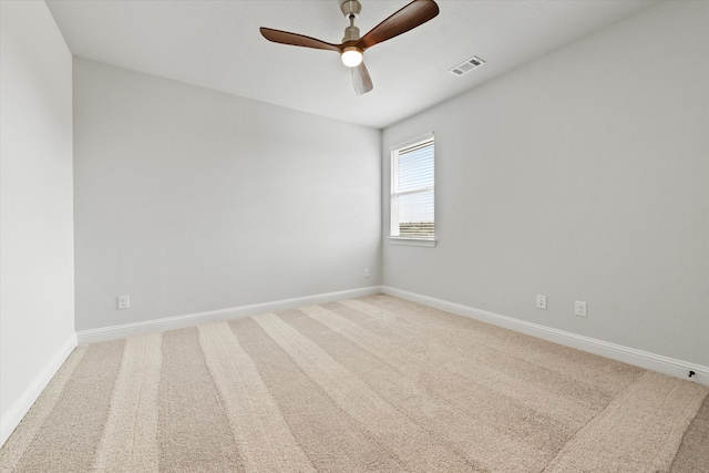 spare room featuring carpet floors and ceiling fan