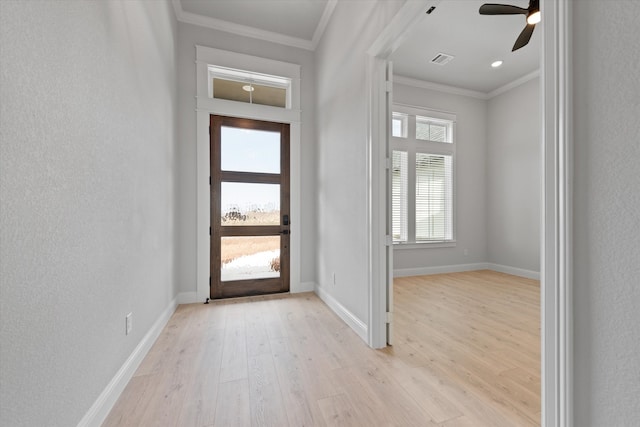 foyer entrance with light wood-type flooring, ceiling fan, and crown molding