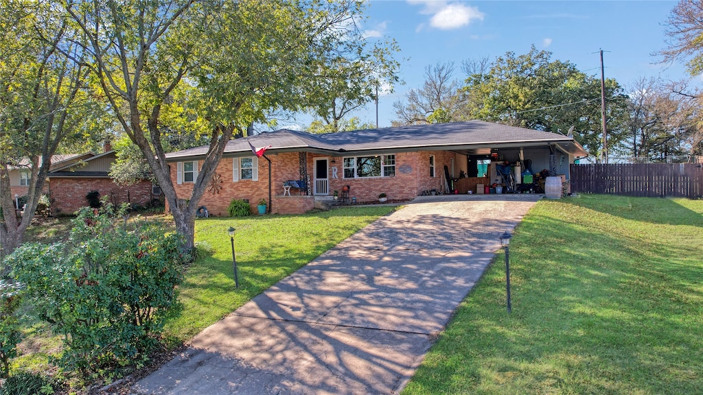 ranch-style home featuring a carport and a front yard