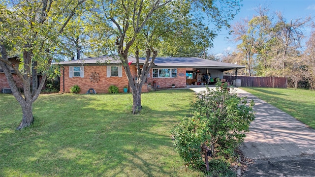 ranch-style home with a front lawn and a carport