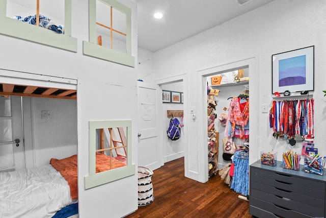 bedroom with dark wood-type flooring