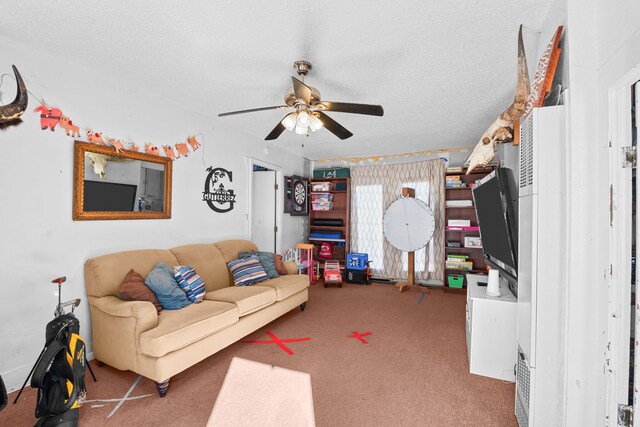 carpeted living room with ceiling fan and a textured ceiling