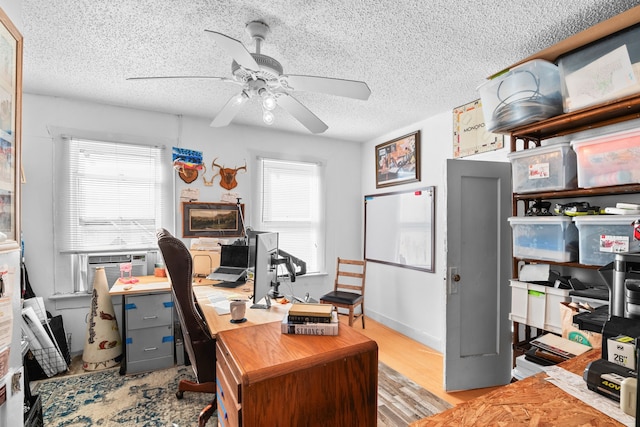 office with ceiling fan, cooling unit, a textured ceiling, and light hardwood / wood-style flooring