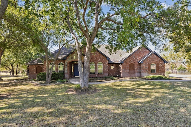 ranch-style home featuring a front yard