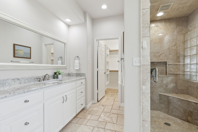 bathroom featuring vanity and an enclosed shower