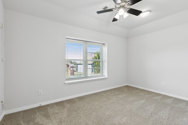 carpeted spare room with ceiling fan