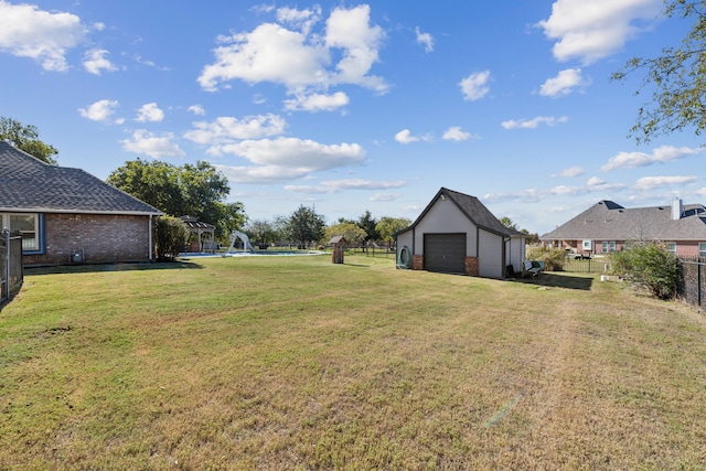 view of yard featuring an outbuilding and a garage