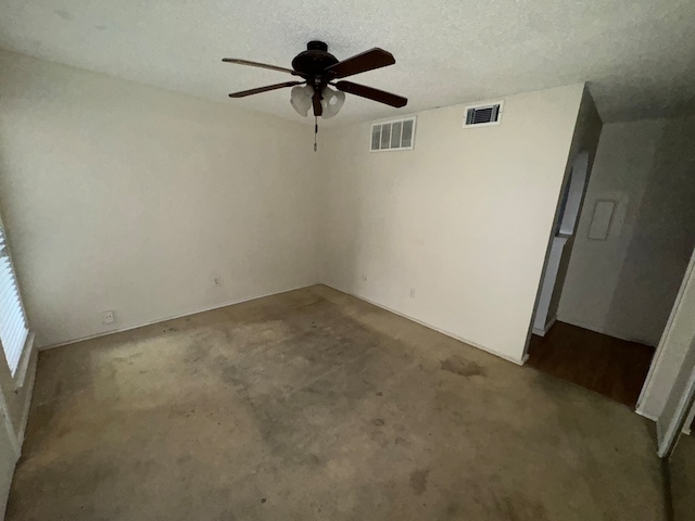 unfurnished room featuring carpet, ceiling fan, and a textured ceiling