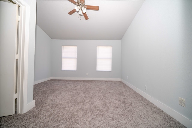 carpeted empty room with ceiling fan and vaulted ceiling