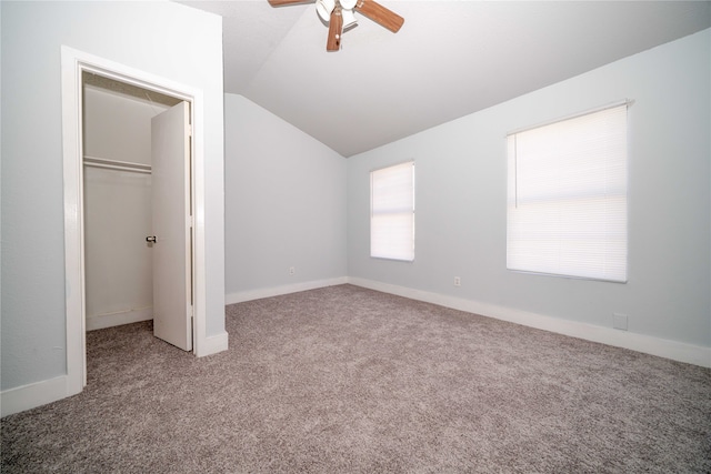 unfurnished bedroom with carpet flooring, ceiling fan, lofted ceiling, and a closet