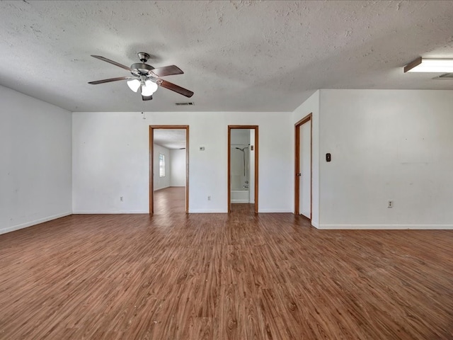 spare room with ceiling fan, wood-type flooring, and a textured ceiling