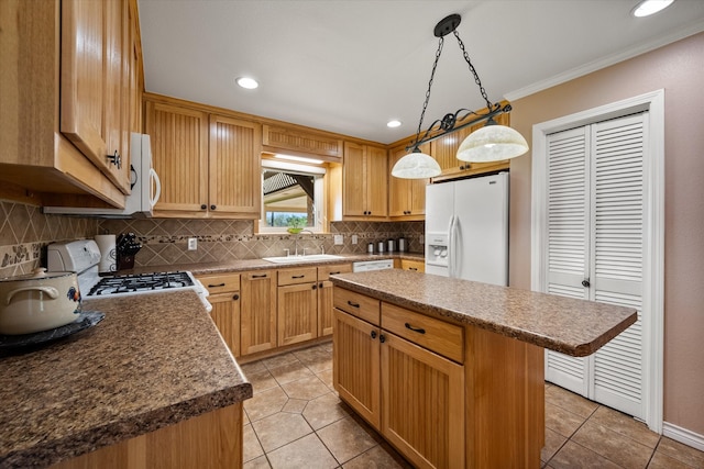 kitchen with sink, tasteful backsplash, pendant lighting, white appliances, and a kitchen island