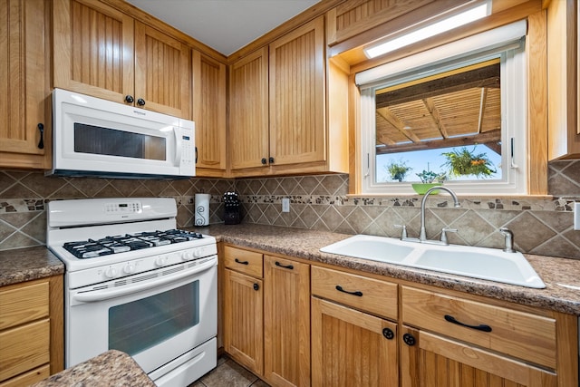 kitchen featuring tasteful backsplash, sink, and white appliances