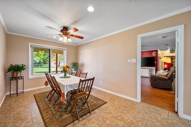 dining room featuring ceiling fan, light wood-type flooring, and ornamental molding