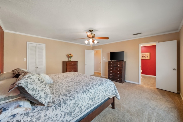 bedroom with light carpet, a closet, ceiling fan, and crown molding