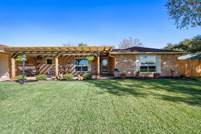 rear view of property with a pergola and a lawn