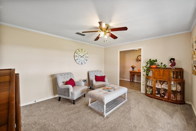 living area with carpet, ceiling fan, and crown molding