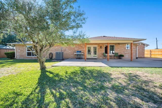 back of house featuring a lawn, central AC, french doors, and a patio