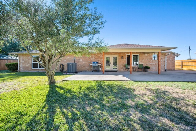 106 Coke St, Streetman, TX 75859 - back of house with french doors, central air condition unit, a patio area, and brick siding