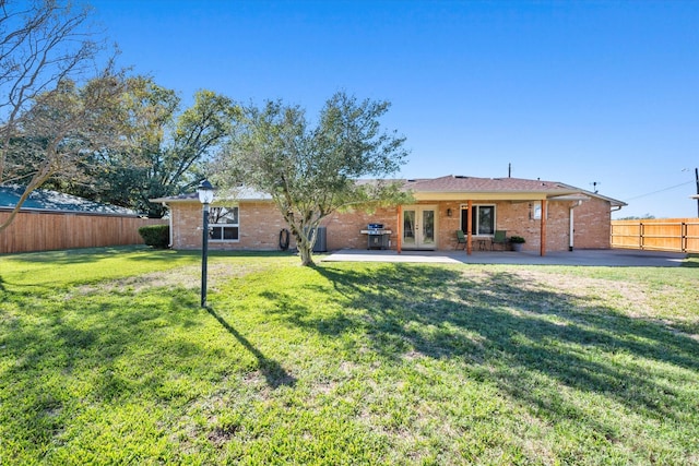 106 Coke St, Streetman, TX 75859 - back of house with french doors, a patio area, and brick siding
