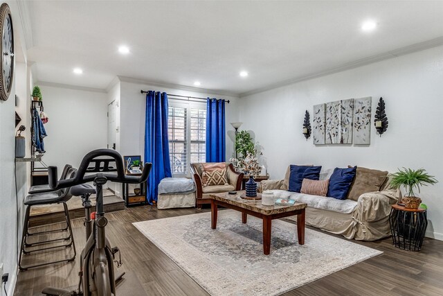 living room with dark wood-type flooring and ornamental molding