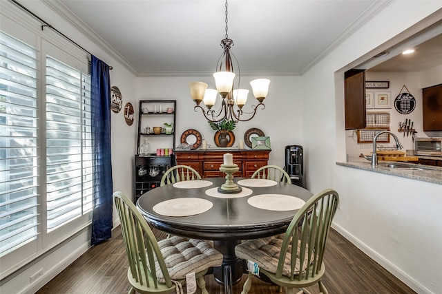 dining space with dark hardwood / wood-style floors, a wealth of natural light, and an inviting chandelier