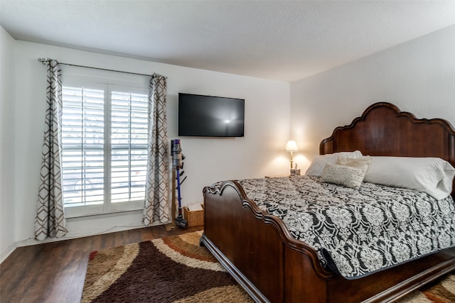 bedroom with dark hardwood / wood-style flooring