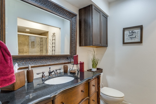 bathroom with vanity, toilet, and walk in shower