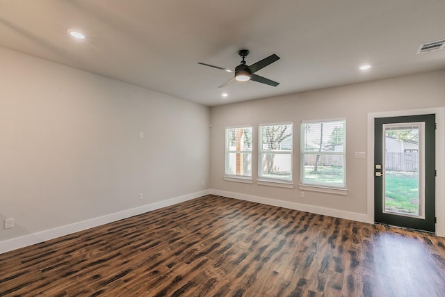 spare room featuring ceiling fan and dark wood-type flooring