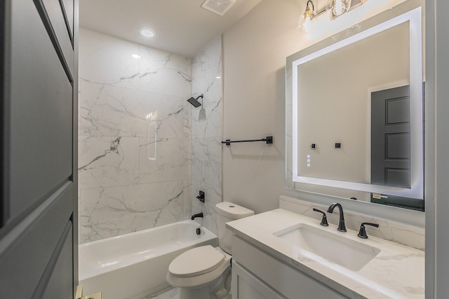 full bathroom featuring tiled shower / bath combo, vanity, and toilet