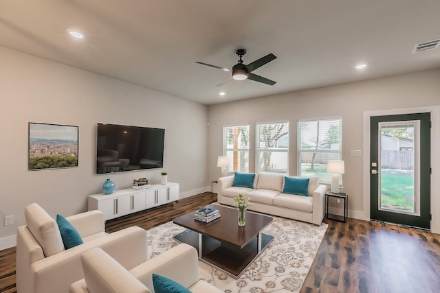 living room with ceiling fan, a wealth of natural light, and wood-type flooring