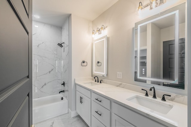 bathroom with tiled shower / bath combo and vanity