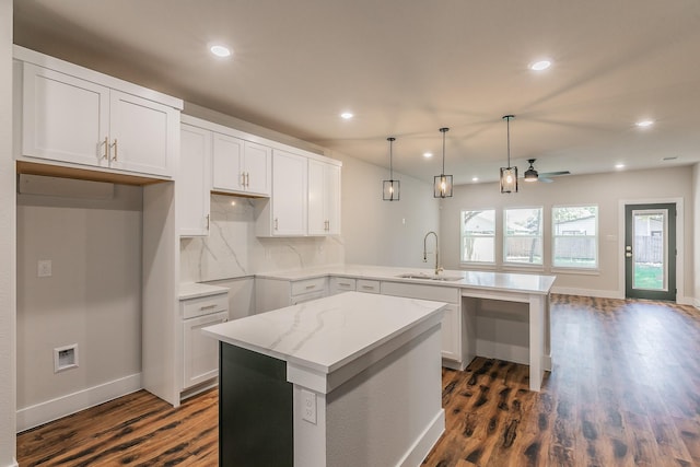 kitchen featuring sink, white cabinetry, and a center island