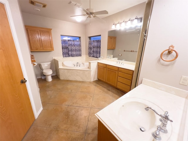 bathroom featuring vanity, ceiling fan, tile patterned flooring, tiled bath, and toilet