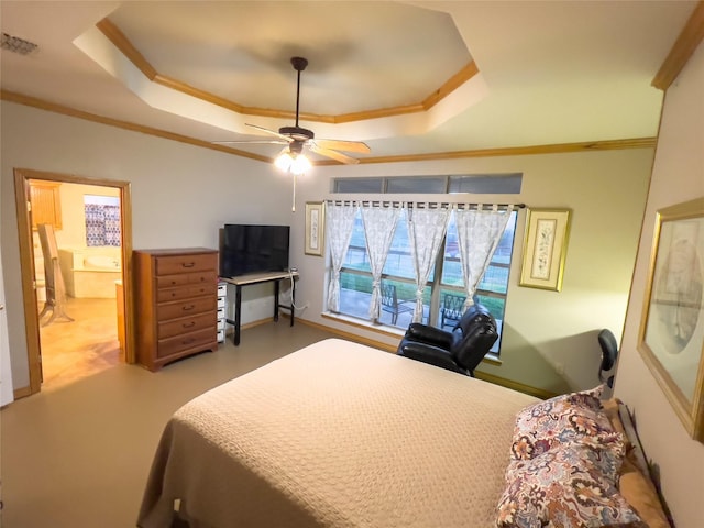 bedroom with ceiling fan, ornamental molding, connected bathroom, and a raised ceiling