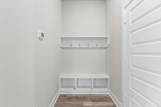 mudroom with baseboards and wood finished floors