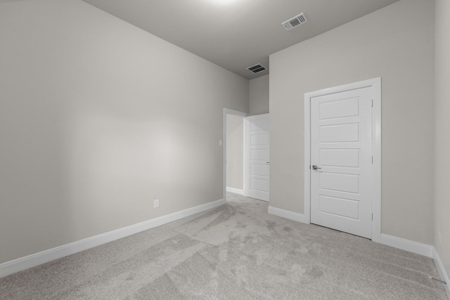 unfurnished bedroom with light carpet, baseboards, and visible vents