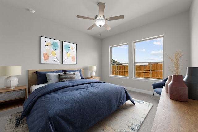 bedroom featuring light carpet, ceiling fan, and baseboards