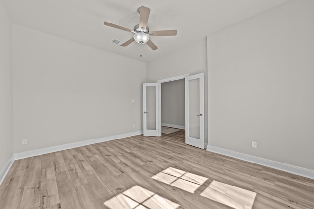 unfurnished bedroom with light wood-style floors, baseboards, visible vents, and french doors